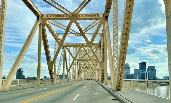 A golden bridge span across a river.