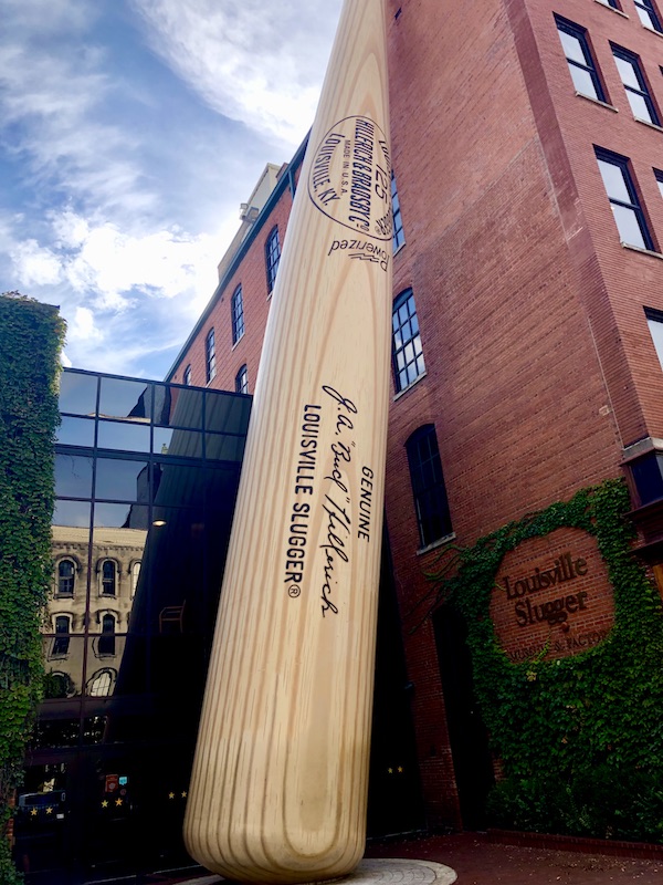 A huge baseball bat leaning against a red brick building in Downtown Louisville Kentucky