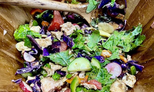 A wood salad bowl filled with fresh veggies fresh from the Farmers Market Nashville TN