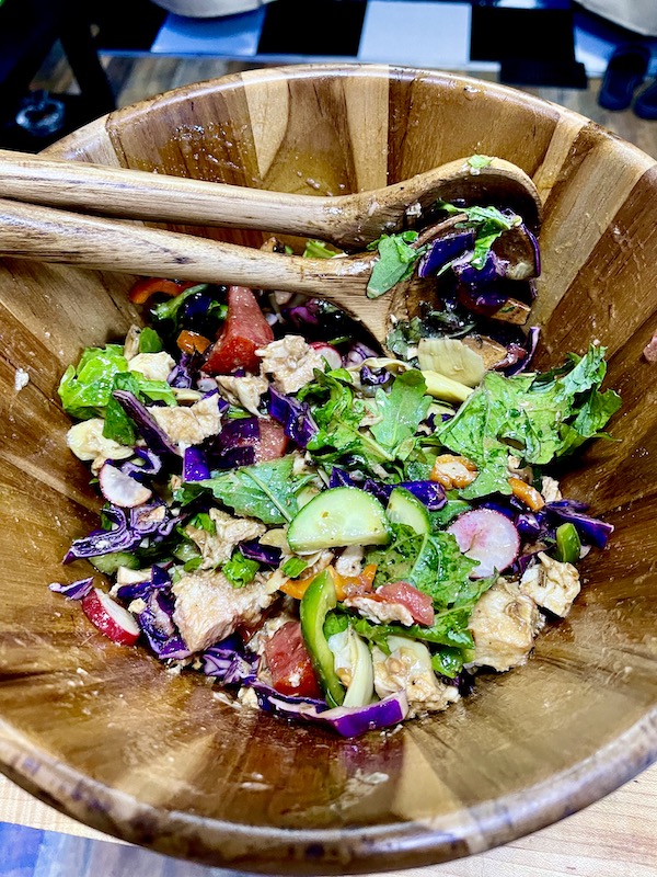 A wood salad bowl filled with fresh veggies fresh from the Farmers Market Nashville TN