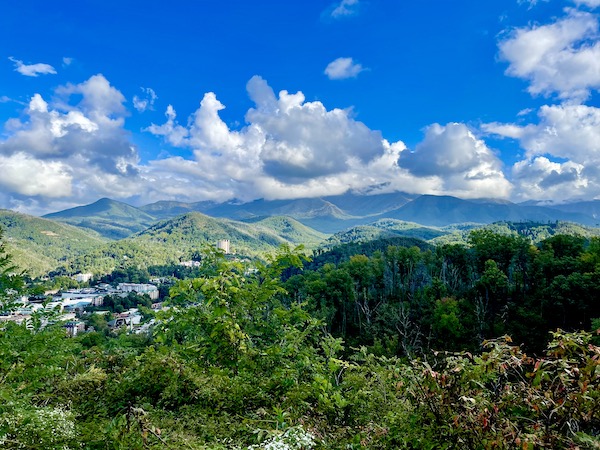 A range of mountains, trees and buildings way below at Great Smoky Mountains National Park