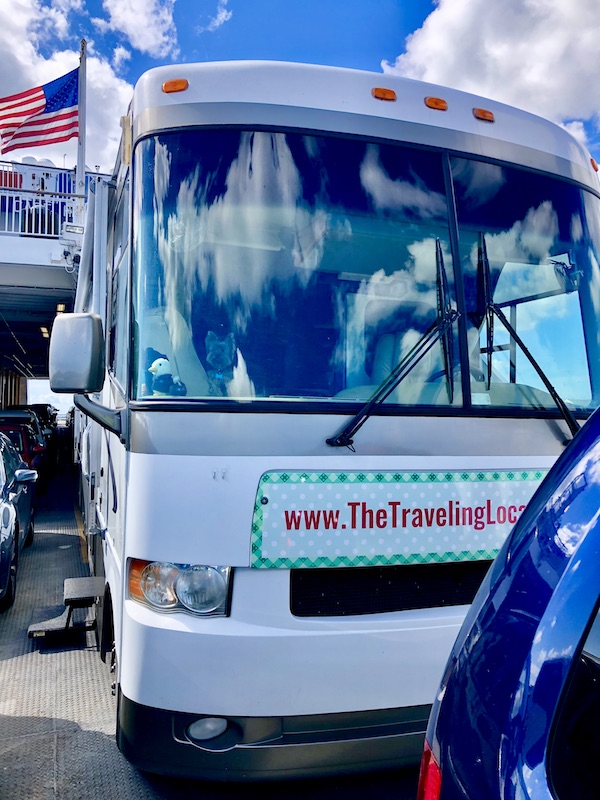 The front of a white RV that's parked on a ferry