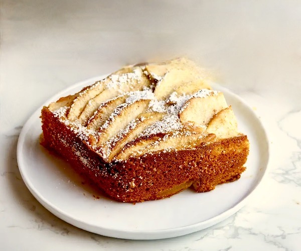A slice of Italian Apple Cake on a white plate.
