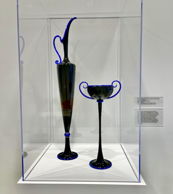 A tall slender pitcher and chalice of blown glass in black and blue at the Knoxville Museum of Art Tennessee