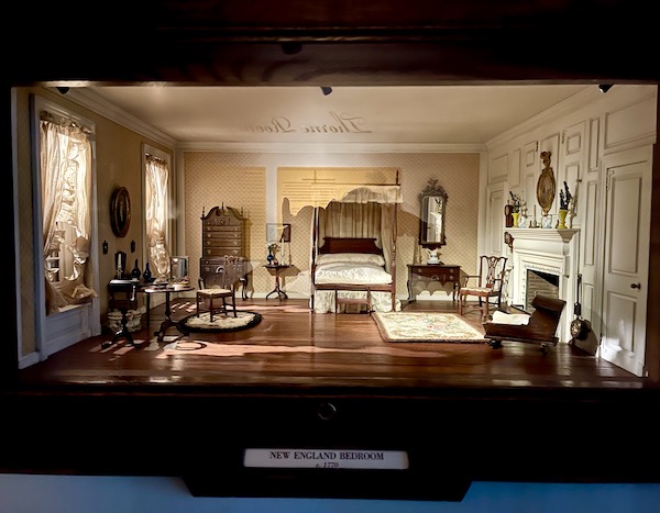 A window looking into a display of and 18th century bedroom created in miniature at the Knoxville Museum of Art Tennessee