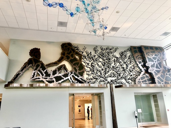 A sculpture of a man and a woman about to embrace just below the ceiling at the Knoxville Museum of Art Tennessee
