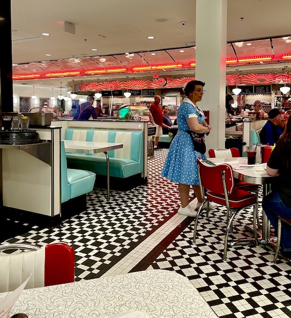 A waitress wearing a blue vintage dress in the Sunliner Diner Pigeon Forge TN