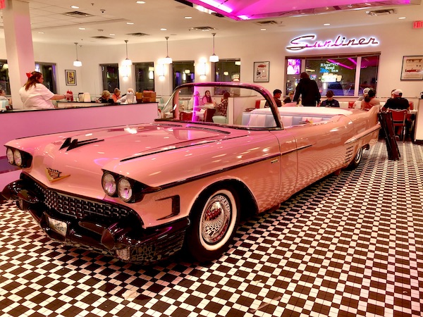 A vintage pink Cadillac convertible is a dining booth at Sunliner Diner Pigeon Forge TN