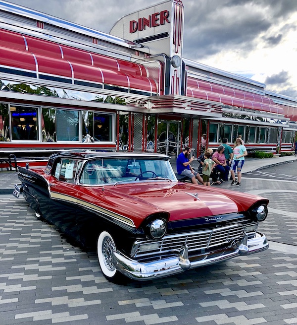 A vintage red and black Ford parked on pavers by the Sunliner Diner Pigeon Forge TN