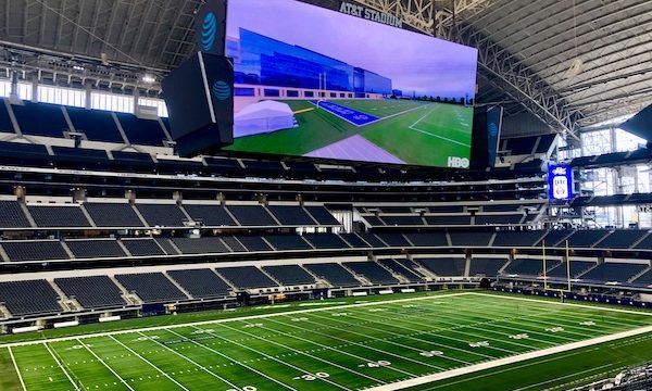 A football stadium with Jumbotrons, field and seating visible during our Dallas Cowboys Stadium Tour