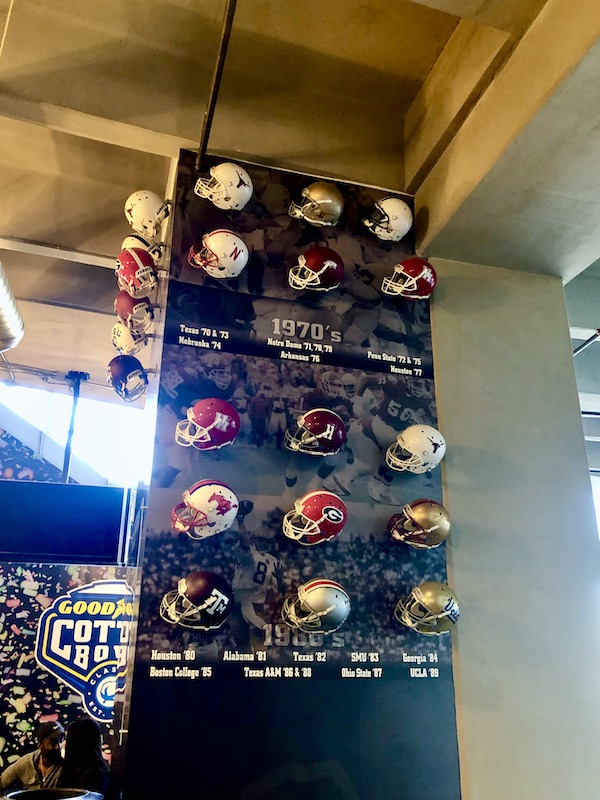 A rotating column of college football helmets.