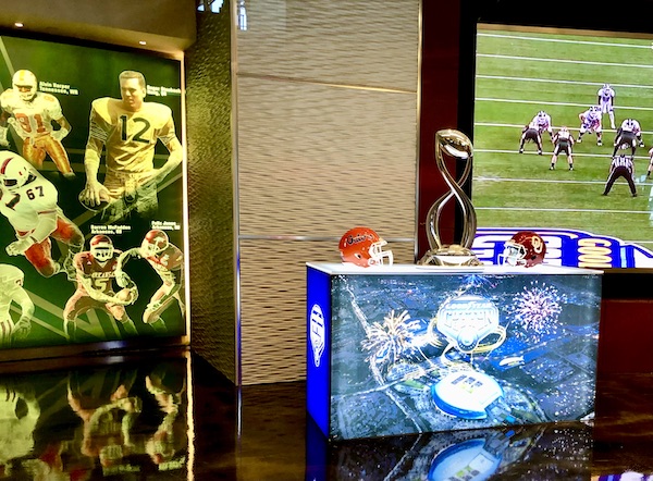 On our Dallas Cowboys Stadium Tour we saw the Cotton Bowl Trophy sitting on a blue and white platform.