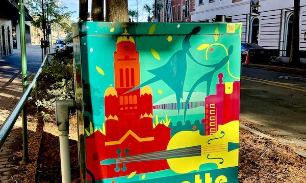 A colorfully painted transformer box in red, green and yellow in Downtown Lafayette Louisiana