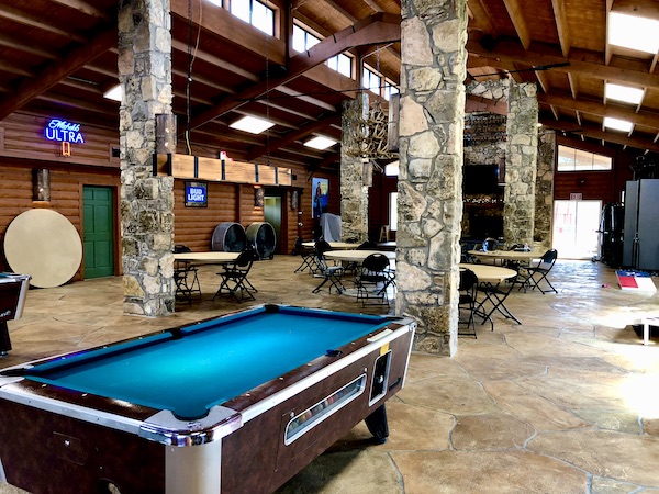 A large room with stone walls and billiards table in Fabulous Austin Texas