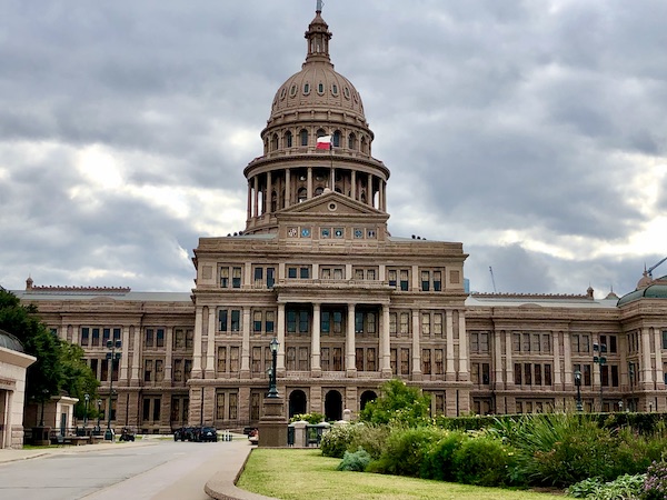 A large beige building with columns and a dome in Fabulous Austin Texas