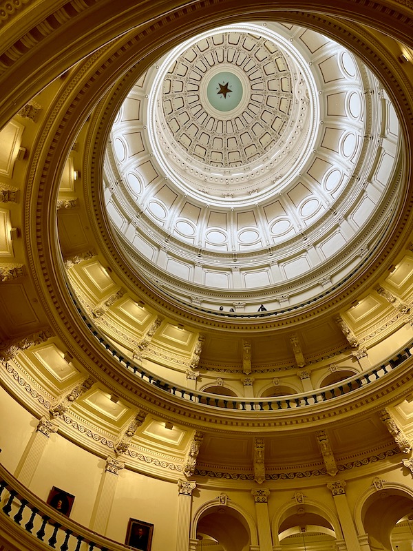 A white dome at the top of a rotunda.