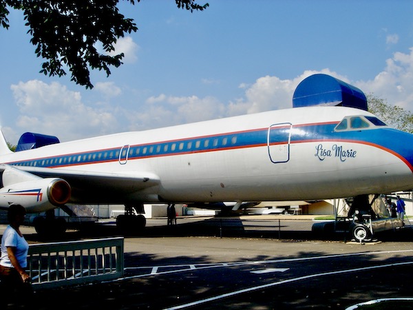 A white and blue jet airliner at Graceland Home of the King