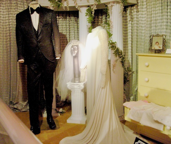Two mannequins, one wearing a black tuxedo and one a white wedding gown on display at Graceland Home of the King