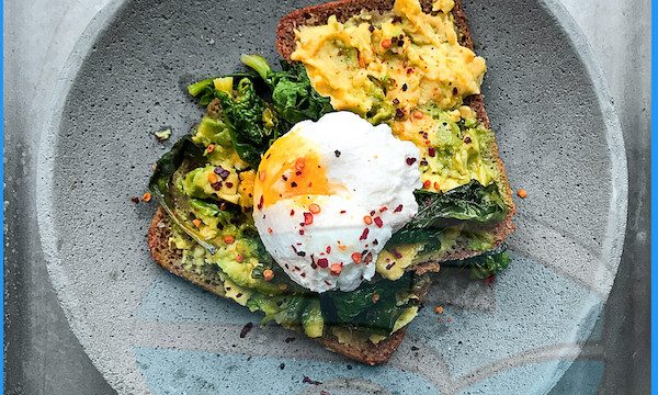 A gray dish topped with two slices of toast with scrambled and poached eggs from Top Hacks for Successfully Observing a Healthy Diet