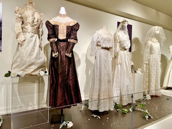 Several wedding gowns and a deep red gown from the early 1900s seen during Abilene Art Walk and Pizza