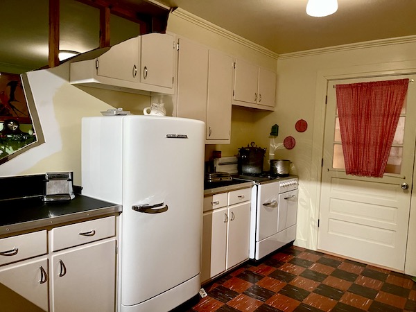 A vintage black and white kitchen with gas stove.