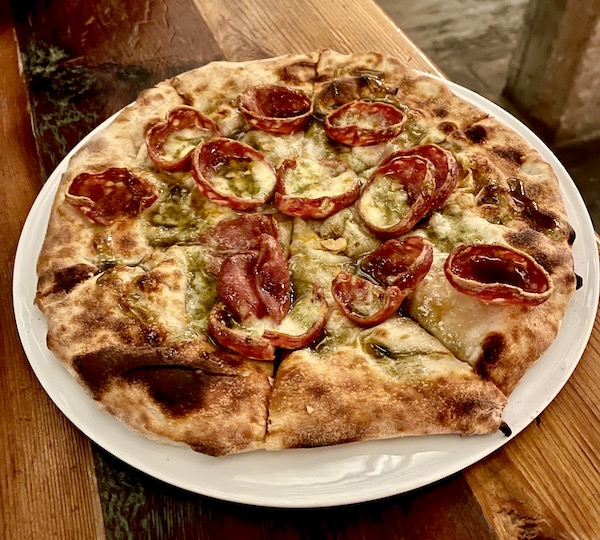 A whole pizza topped with slices of crispy edged salami was the pizza part of Abilene Art Walk and Pizza