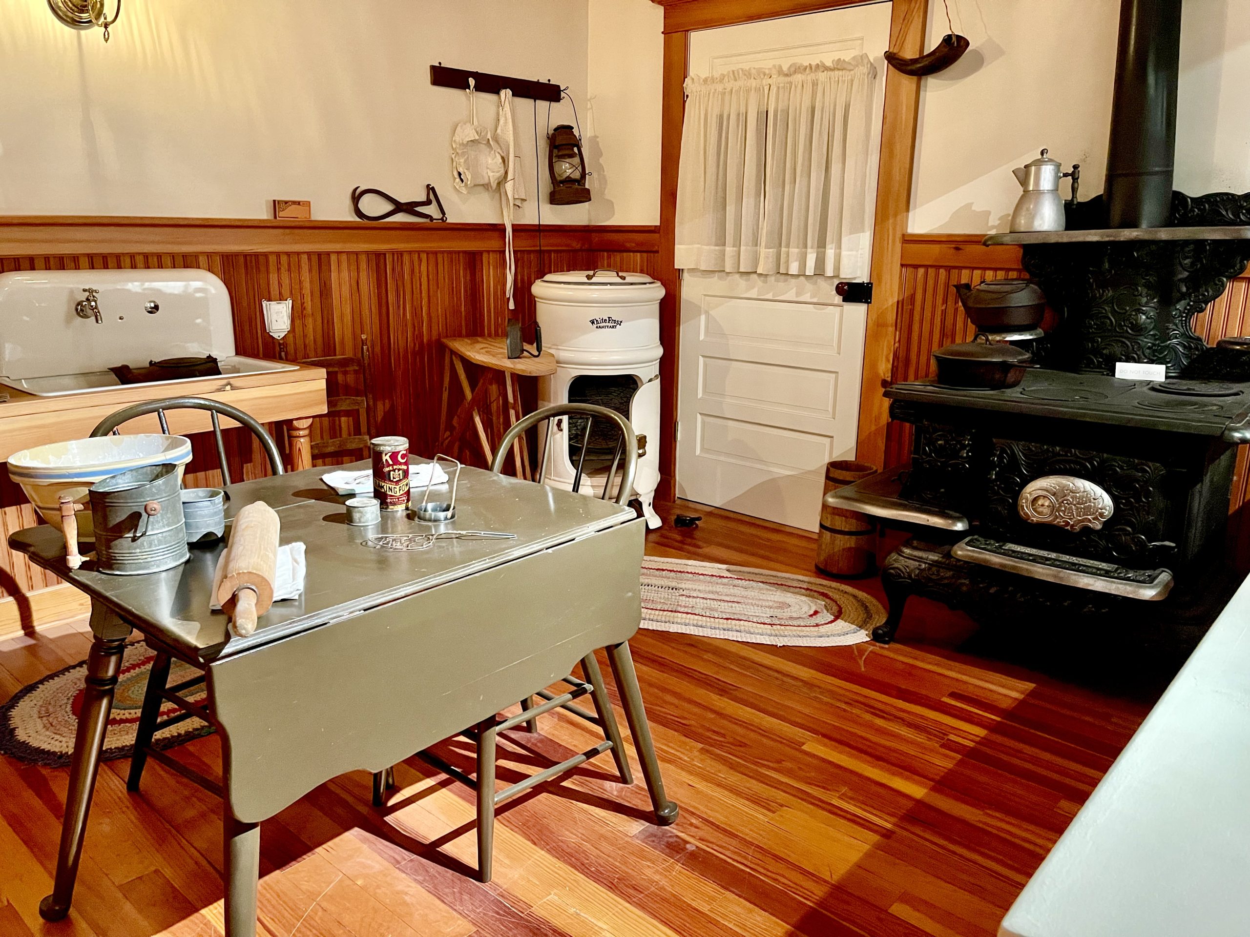 An old kitchen with wood burning stove and drop leaf table from Abilene Art Walk and Pizza