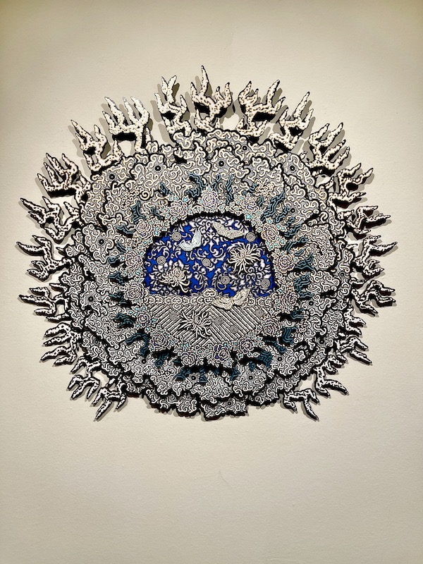 A white, black and blue intricate pattern in circular shape from the Abilene Art Walk and Pizza