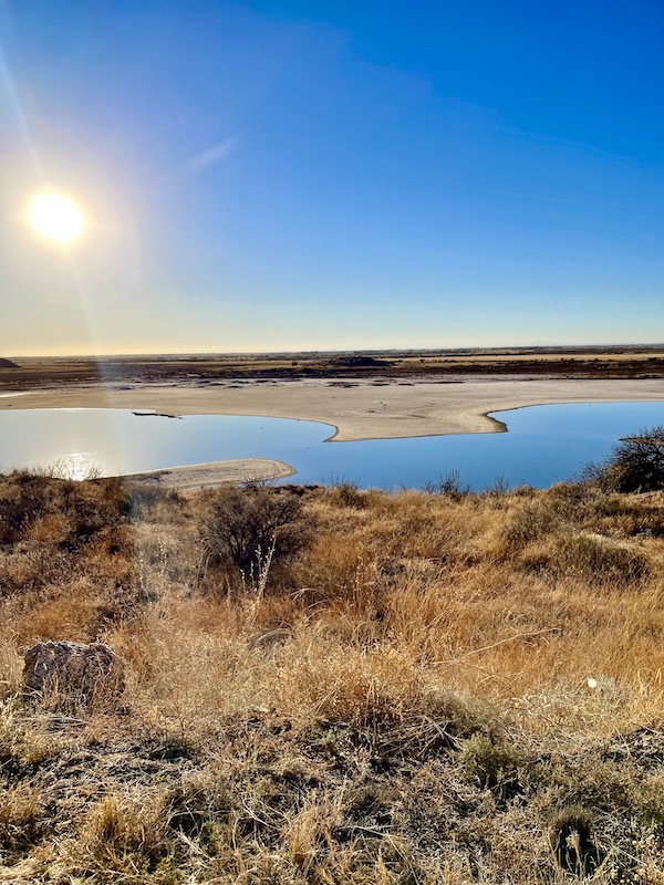 Sun reflecting in a lake surrounded by rocks at Bottomless Lakes State Park Roswell NM