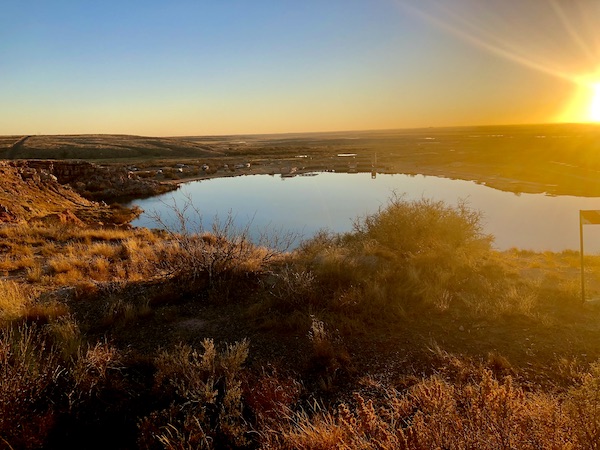 The sun setting behind the mountain and lake at Bottomless Lakes State Park Roswell NM