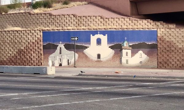 A mural on the highway depicting 3 white churches along the El Paso Texas Mission Trail