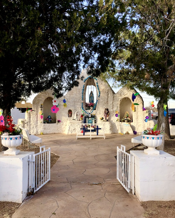 A white stone, Spanish style shrine at a church along the El Paso Texas Mission Trail