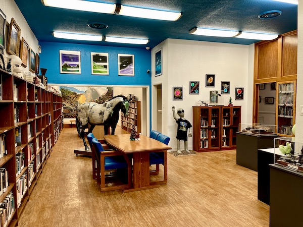 A wood floor, desks and shelves of books at the International UFO Museum Roswell NM