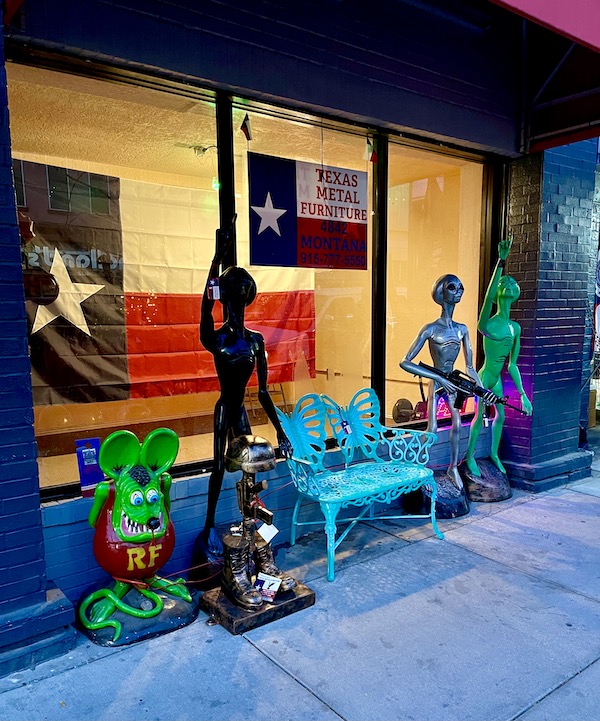 A storefront with fun colorful statues of aliens in front in El Paso TX.