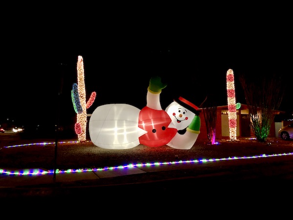 A blow up balloon Frosty the snowman lying on its side, Christmas decoration.