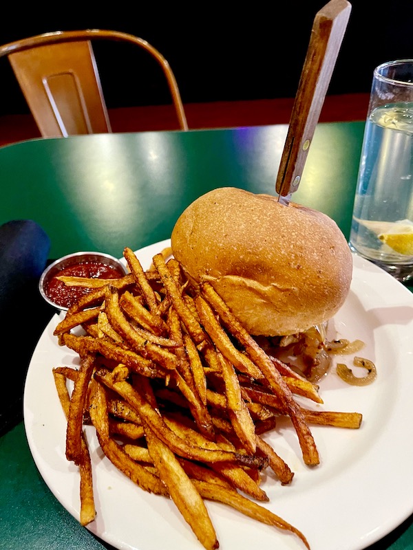 A white plate topped with a burger and fries from Our Trip to Mexico and Lunch