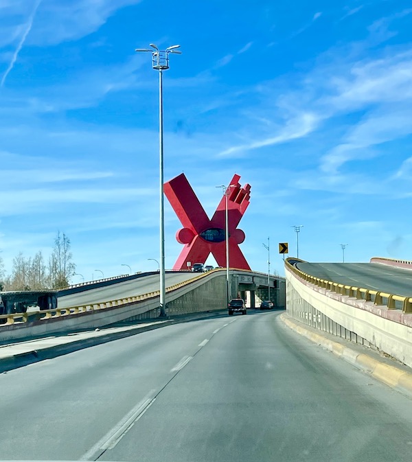 A big red x sculpture at the crest of a hill from Our Trip to Mexico and Lunch