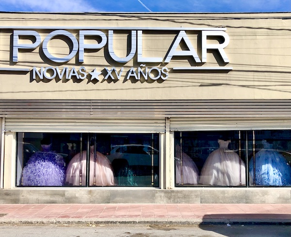 A store front with ball gowns displayed in the windows from Our Trip to Mexico and Lunch