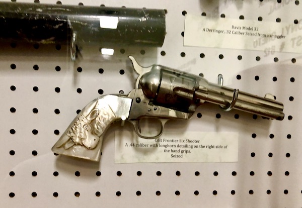 Guns display on ivory pegboard at the US Border Patrol Museum El Paso