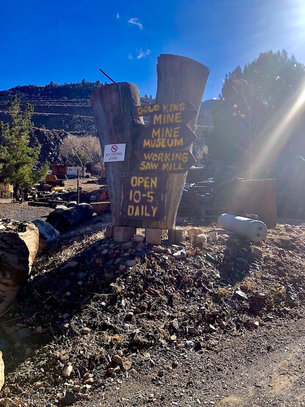 Large brown sign with gold writing at the Friendly Ghost Town Haynes AZ