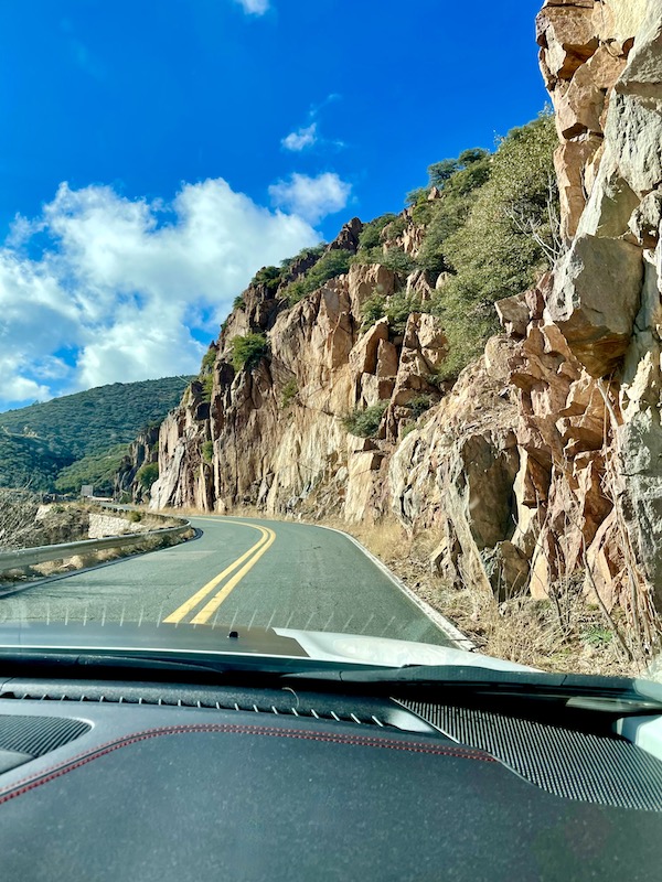 A mountain road seen through the windshield of a car when driving to Haunted Hamburger Restaurant Jerome AZ