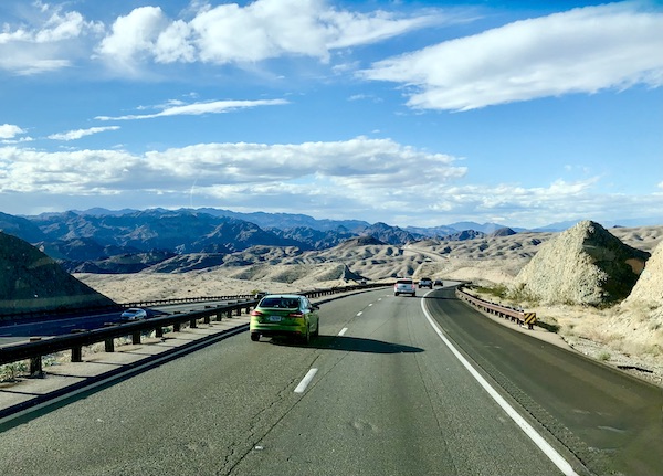 Black mountains, highway, cars and desert en route to Hoover Dam Lake Mead NV