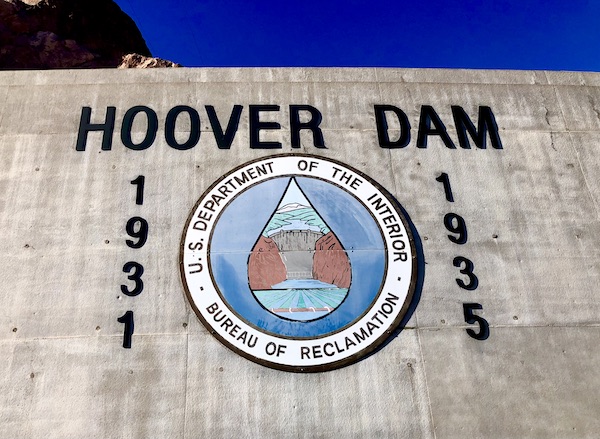 On the face of Hoover Dam are the years of construction and a symbol of water management.