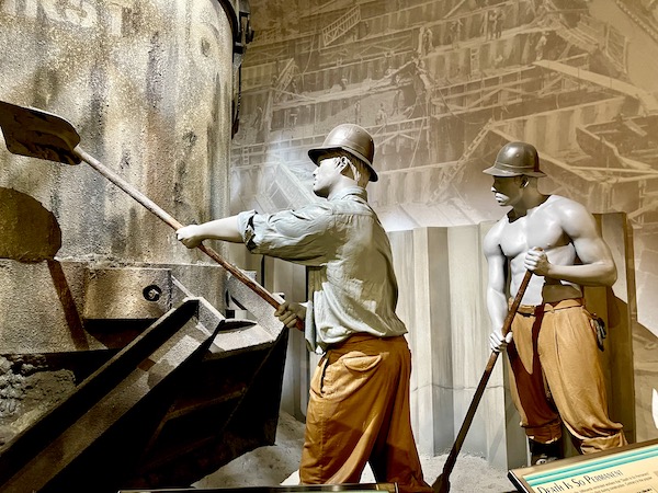 Sculptures of men in hard hats working, inside Hoover Dam