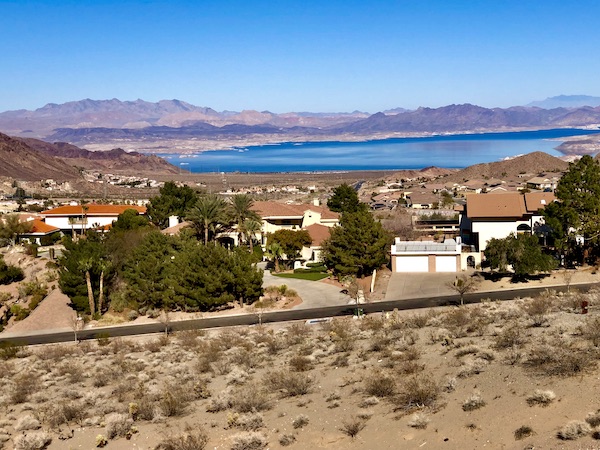Lake, mountains and homes in the desert.