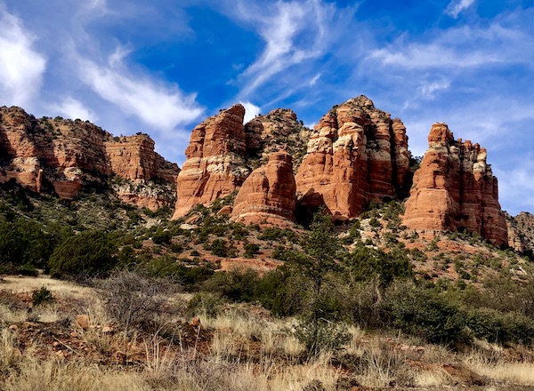 A range of mountains with white stripes, part of the Red Rocks of Sedona Arizona