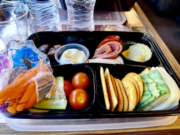 A black plastic clamshell holding cold cuts, cheeses, crackers and veggies on our Verde Canyon Railroad Wilderness Route
