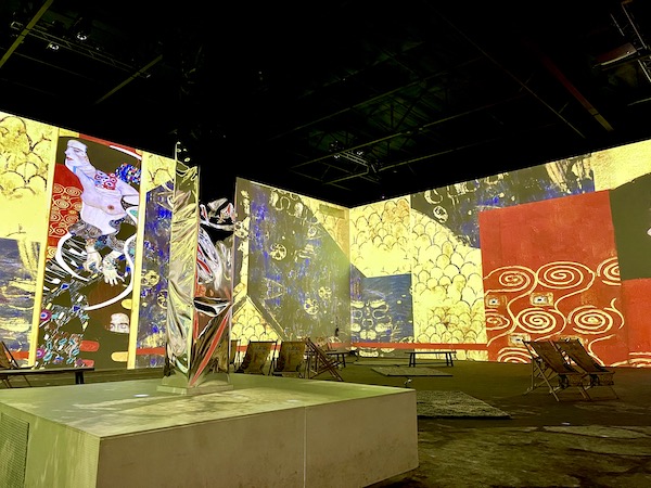 Many paintings are projected on the walls in multiple colors at the Gustav Klimt: The Immersive Experience