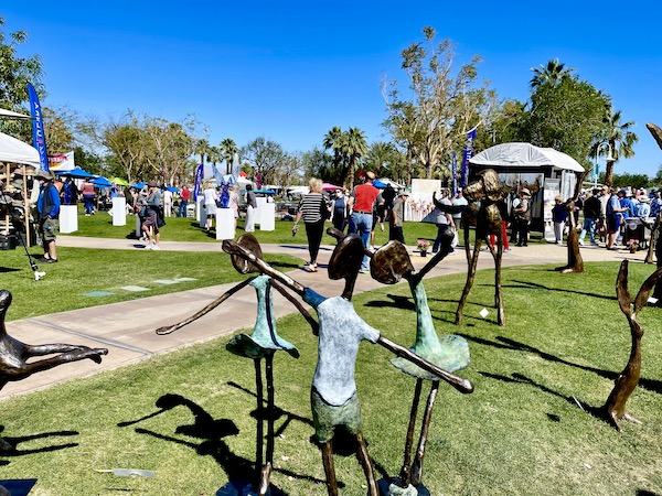 Lawn at La Quinta Art Celebration California with whimsical sculptures of rabbits and children.