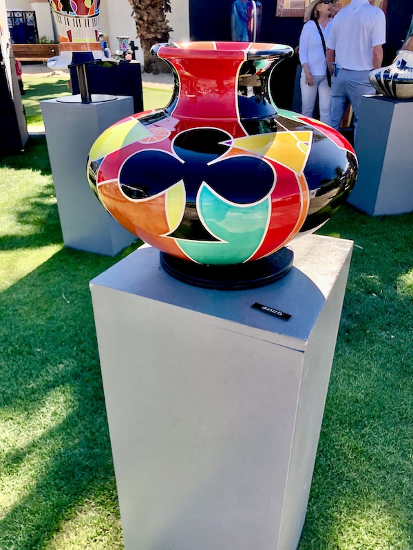 A boldly colored ceramic vase on a light gray pedestal at La Quinta Art Celebration California